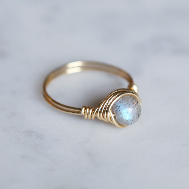 side angle of labradorite gemstone ring with blue flash reflecting from stone