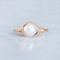 photo of a pearl solitaire ring wrapped in 14k gold-filled wire