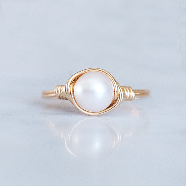 photo of a pearl solitaire ring wrapped in 14k gold-filled wire