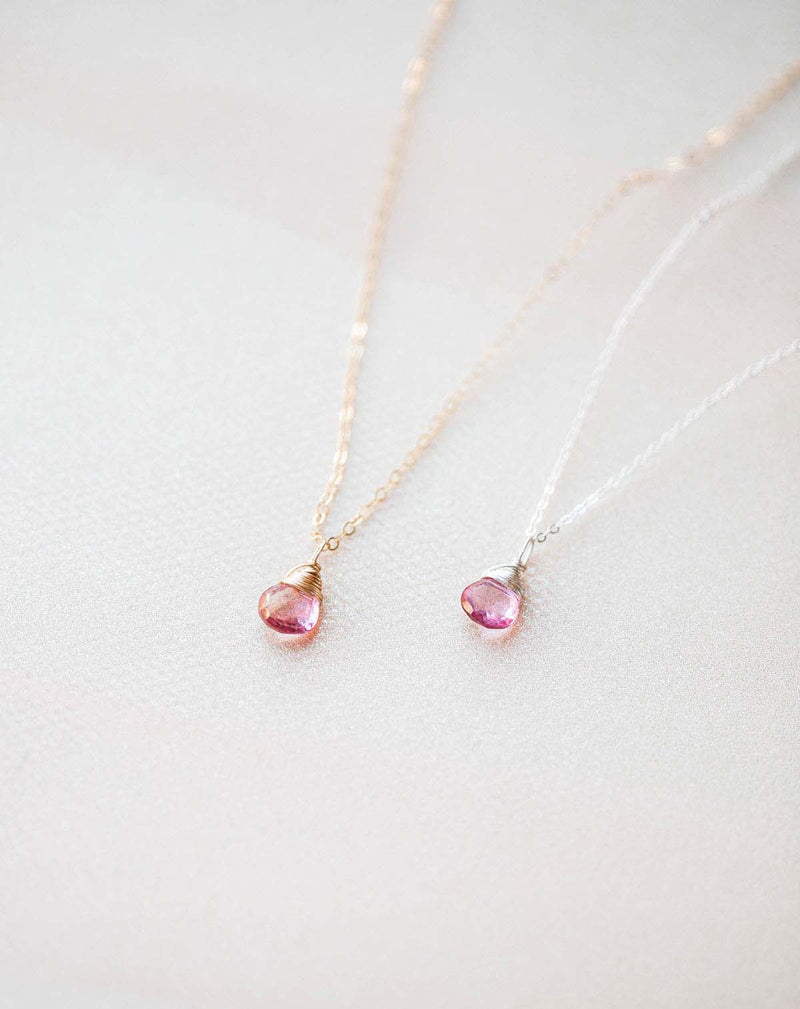 photo of two pink topaz gemstone necklaces made of gold and silver