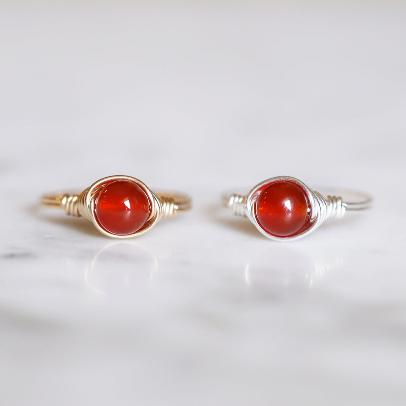 two carnelian rings displayed from left to right settings in 14k gold filled and sterling silver