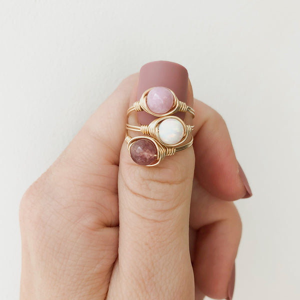 photo of gemstone rings stacked on a thumb