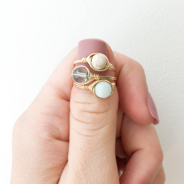 photo of a gemstone ring stack displayed on a finger