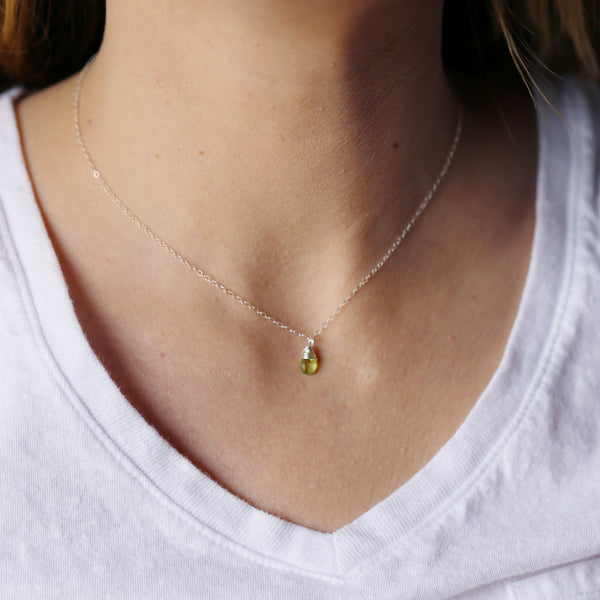 peridot gemstone necklace on person